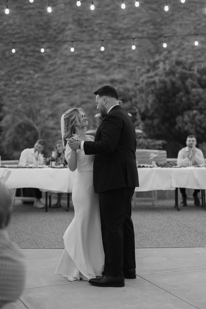 bride and groom outside under the lights dancing at their Lambs Fellowship wedding
