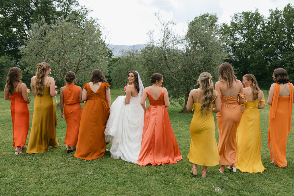 bride and her bridesmaids in their colorful dresses at her Villa il Palagio wedding in tuscany